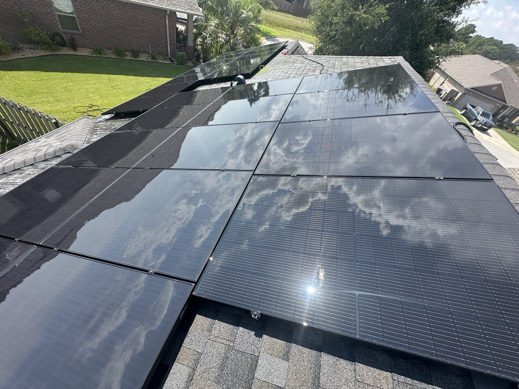 Glossy clean solar panel array reflecting the sky after washing