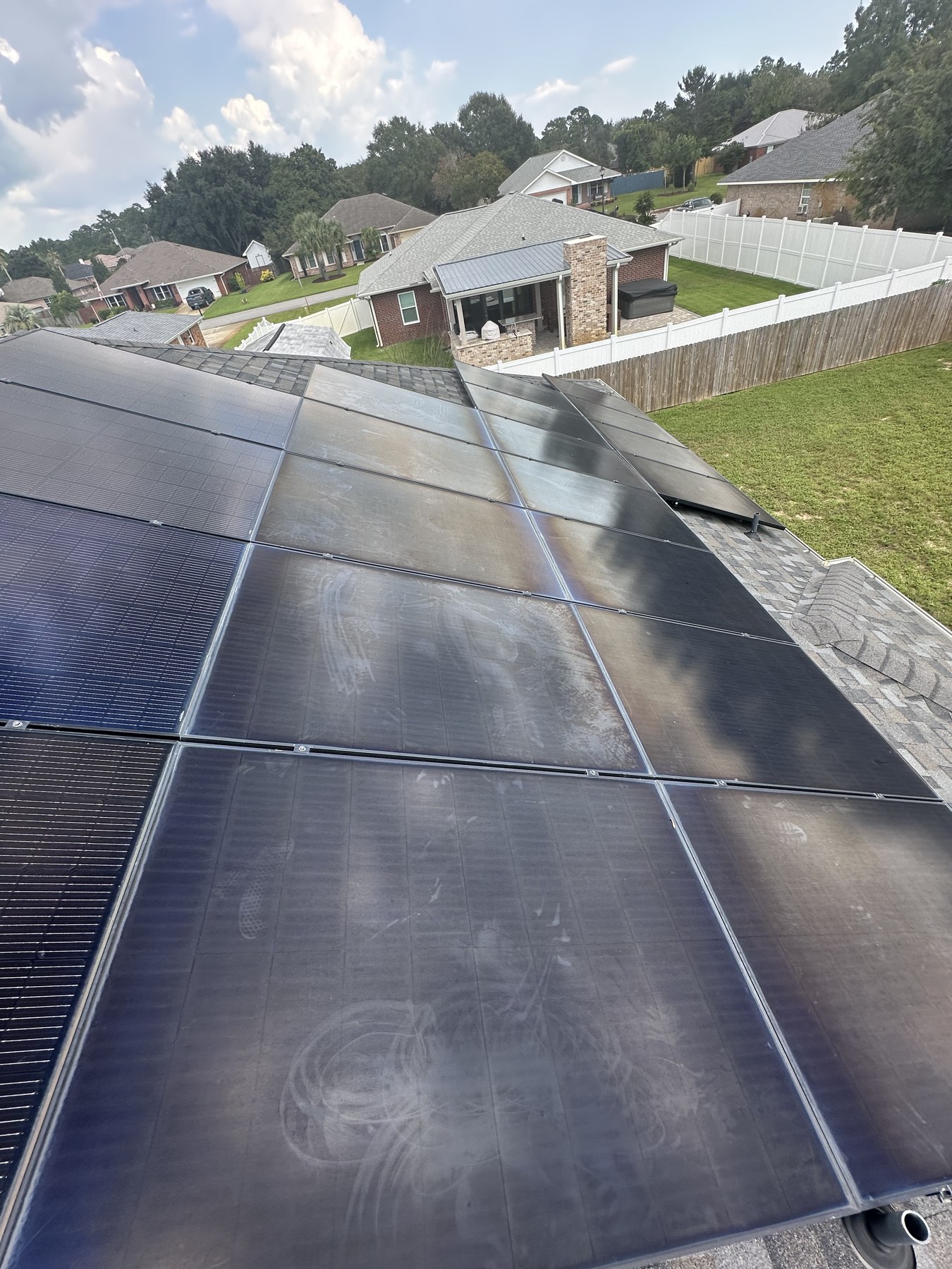 Solar panel array with cloudy residue before cleaning